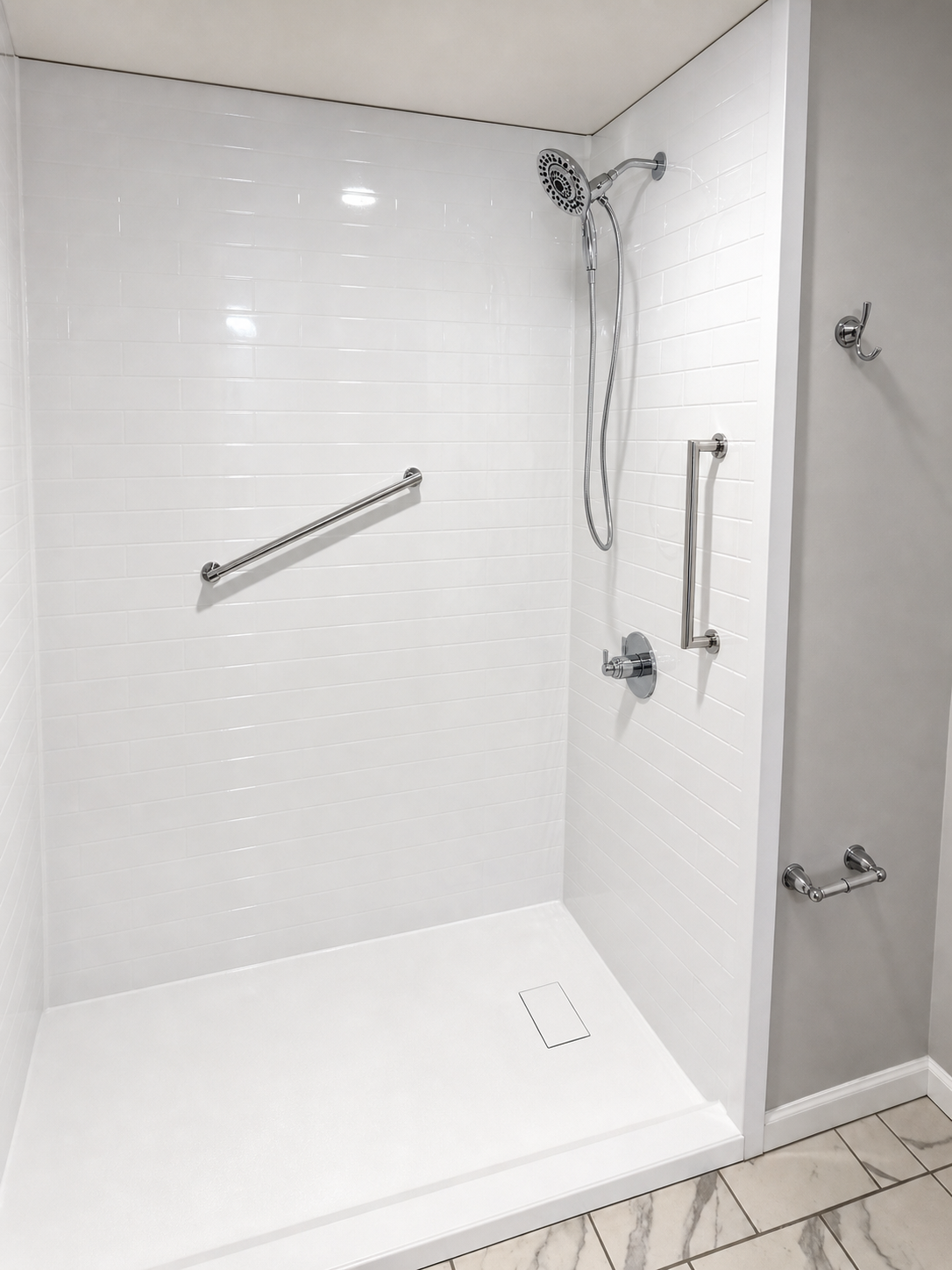 Completed accessible walk-in shower with white subway-style walls, chrome handheld shower and safety grab bars in Lexington, NC