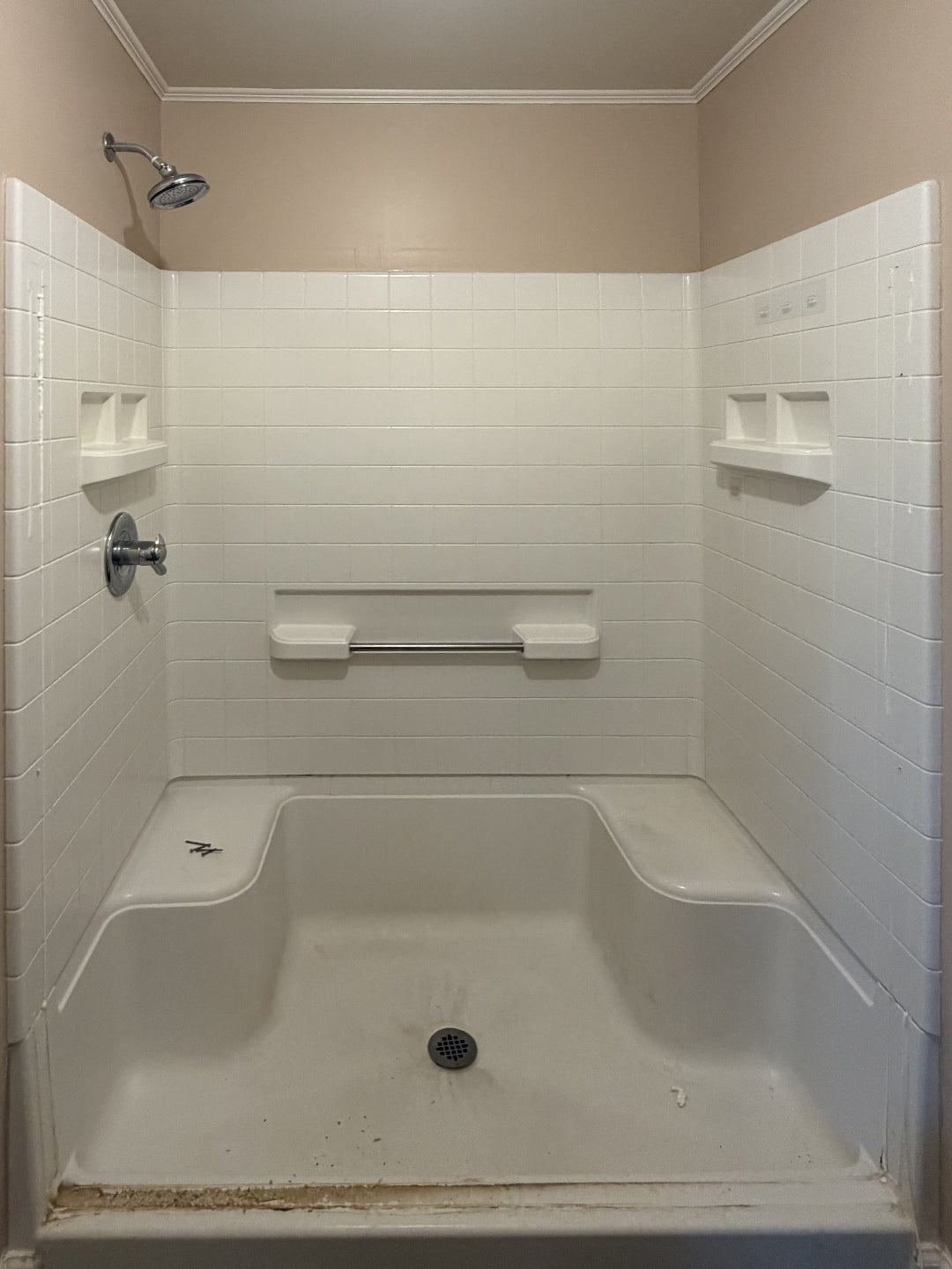 Before: original molded shower with built-in seats